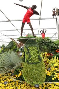 Usain bolt in wicker ontop of a flower shoe